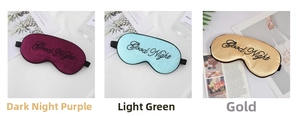 Detailed close-up of three faux silk sleep masks with Good Night embroidery in various colors
