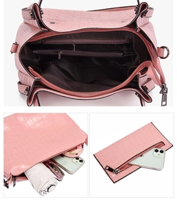 Macro view of pink crocodile pattern handbag interior with zipper pockets and liner