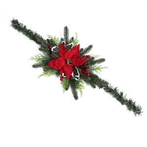 Christmas garland with red poinsettia, pine cones and berries for festive garden decoration