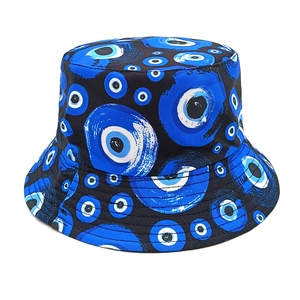 Close-up of cotton bucket hat with evil eye pattern and reinforced stitched brim