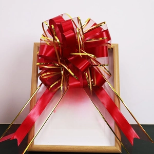 Detail of a large red and gold decorative bow ribbon for wedding car and gift wrapping