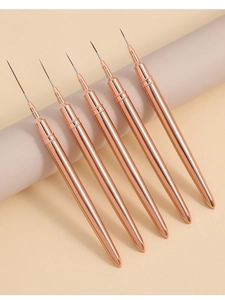 Macro detail of 5 rose gold nail art liners with fine tips for professional drawing