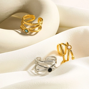 Macro shot of gold and silver multi-layer crossover rings with mother of pearl inlay