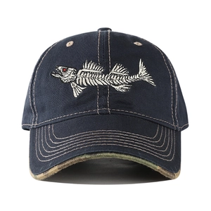 Detail view of navy baseball cap with white fishbone embroidery and camouflage brim