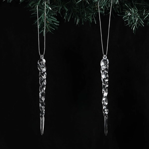 Transparent twisted icicle Christmas tree ornaments with silver strings on pine branch