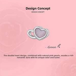 Macro detail of 925 silver double heart charm with natural pink mother of pearl inlay