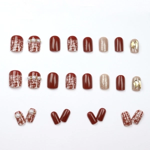 Deep wine red press-on nails with champagne gold glitter and elegant pearl accents