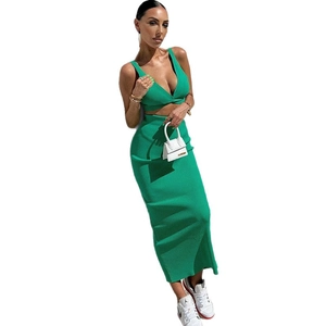 Women's two-piece green ribbed knit set with deep V-neck crop top and high waist maxi skirt