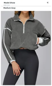 Detail of grey sherpa fleece jacket featuring half-zip collar and white contrast stripes