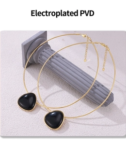 Detail of PVD electroplated gold necklace with black agate geometric pendant