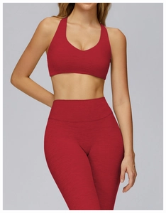 Detail of red heathered knit texture on racerback sports bra and seamless leggings