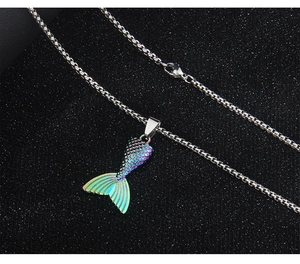 Macro view of colorful gradient mermaid tail pendant with elegant silver box chain