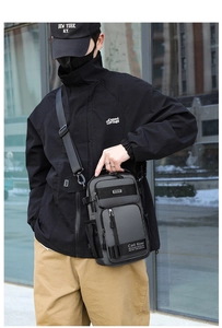 Detail view of dark grey multifunctional chest bag with adjustable shoulder strap and buckles