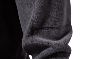 Close-up of the dark grey polar fleece fabric showing premium stitching and soft texture