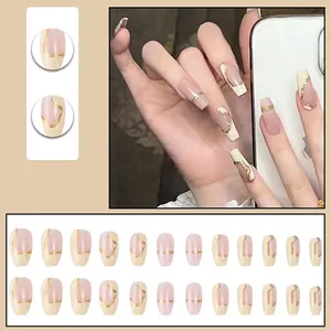 Short ballerina press-on nails with nude pink and cream white french tip gold foil