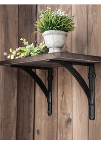 Detail of industrial black iron triangle shelf bracket with solid wood textured shelf board