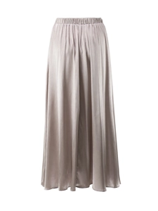 Close-up of the champagne satin fabric texture and elastic waistband on a midi skirt