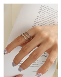 Close-up of double-layer twist spiral ring in silver finish on hand with minimalist beads