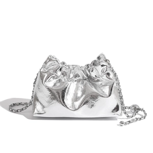 Detailed view of silver pleated cloud bag with metallic finish and sphere chain strap