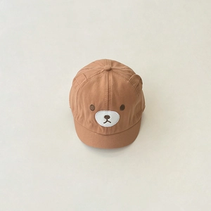 Close-up of brown baby baseball cap featuring 3D bear ears and soft cotton texture