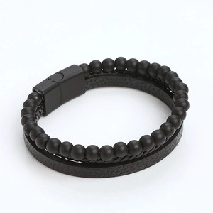 Detail of men's double-layer black leather bracelet with matte stone beads and magnetic clasp