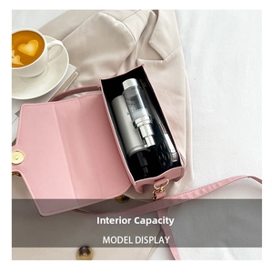 Pink leather handbag interior showing capacity for smartphone and cosmetic bottle