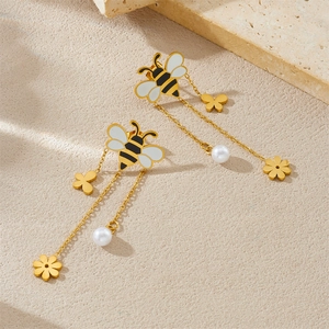 Elegant long tassel bee earrings with pearl drops and gold flower charms on stone surface