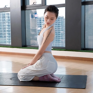 Women's cotton five-toe yoga socks with non-slip grips in a cozy indoor setting