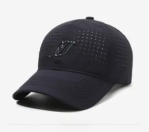 Detail view of navy blue mesh baseball cap showing laser-cut side vents and 3D embroidery