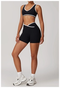Detail of cross high waist shorts and contrast piping on black yoga sports set