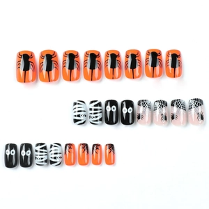 Halloween press-on nail kit featuring black spider webs and cartoon eyes patterns