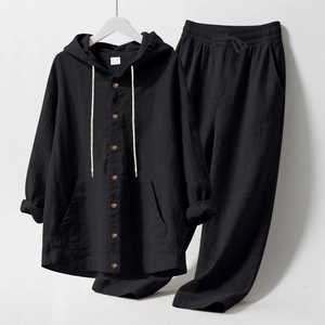 Detail of black linen lounge set featuring hooded button shirt and drawstring pants