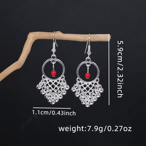 Detail view of ethnic silver drop earrings with red beads showing dimensions and weight