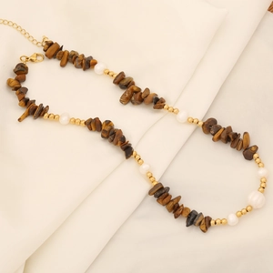 Natural stone and pearl necklace on white silk background with stainless steel clasp