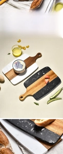 Detail of acacia wood and marble cutting board with handle and round hanging hole