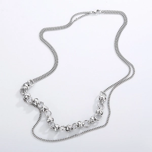 Detail of silver double-layered stainless steel necklace with woven chain and round links