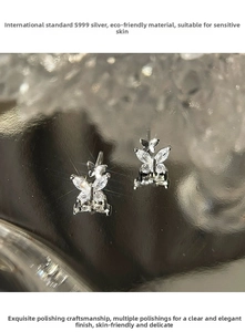 Macro shot of S999 silver butterfly stud earrings with marquise-cut sparkling zircons