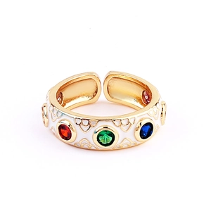 Top view of gold open ring with white enamel patterns and colorful zircon gemstones