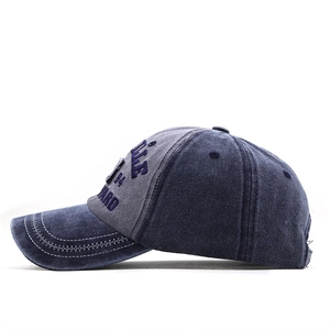 Detail of vintage washed baseball cap featuring 3D letter embroidery and contrast stitching