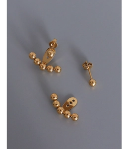 Macro view of gold ear jacket component with five polished steel beads in arc arrangement