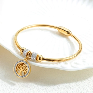 Elegant gold tree of life titanium steel bracelet with rhinestones on white ceramic plate