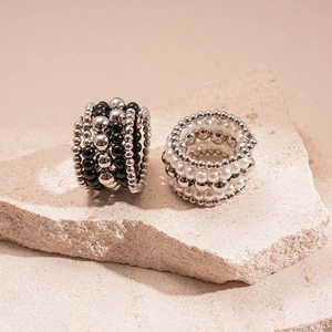 Multi-layer beaded rings featuring faux pearls, black beads and silver metal spheres