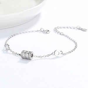 Close-up of S925 sterling silver bracelet featuring a zircon-studded cylindrical charm