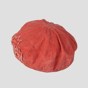 Detailed close-up of retro washed red canvas beret with lace flower applique