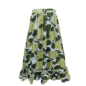 Detail of high-waist A-line skirt with green hydrangea print and ruffled hemline