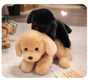 Close-up of black and golden Labrador plush puppies with realistic long faux fur texture