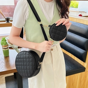 Trendy black quilted round crossbody bag set with gold hardware and wide strap