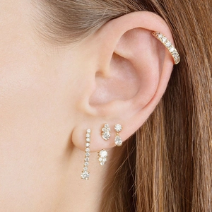 Close-up of gold ear cuff and stud set with white teardrop and round zircon stones