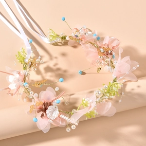 Detail of bridal floral headband with pink tulle flowers, gold butterflies and pearls