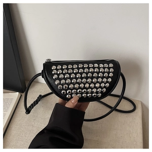 Detail of black PU leather half-moon crossbody bag with silver rivet studs decoration